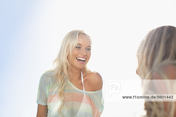 Smiling women talking outdoors