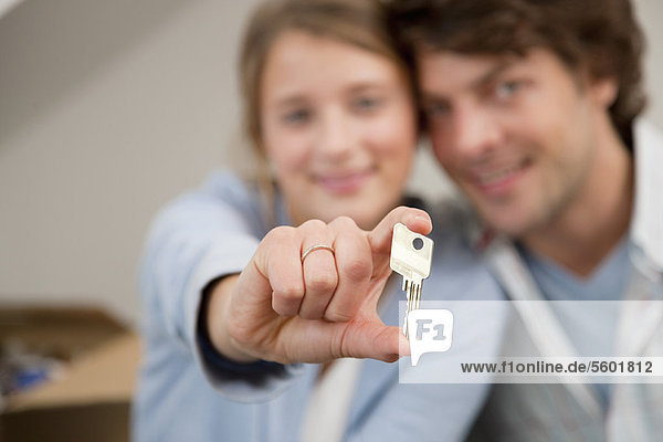 Woman holding key to new home