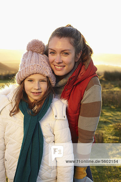 Mother and daughter smiling outdoors