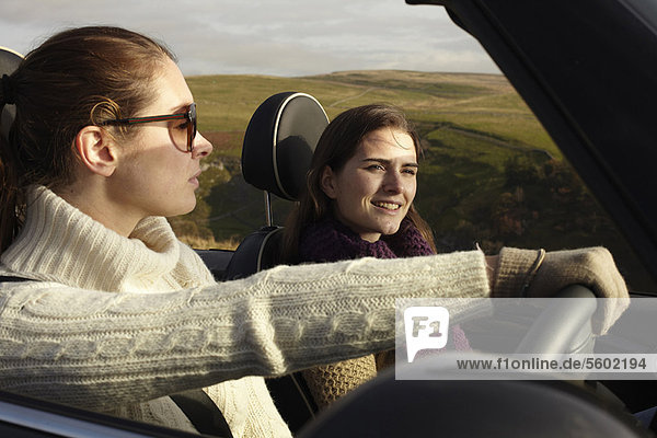 Women driving in rural landscape