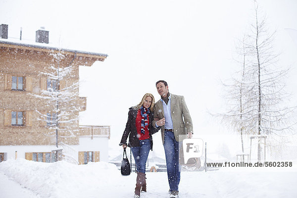 Couple walking together in snow