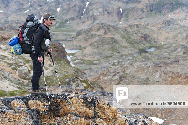 Leader of a group of hikers with a backpack and a rifle  Ammassalik Peninsula  East Greenland  Greenland
