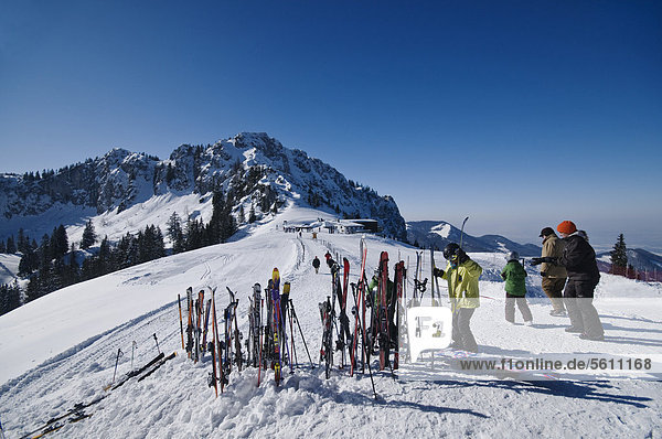 'Mountain station ''Kampenwandbahn''  with skis upright in the snow  skiers fetching their skis  Aschau  Chiemgau region  Bavaria  Germany  Europe'