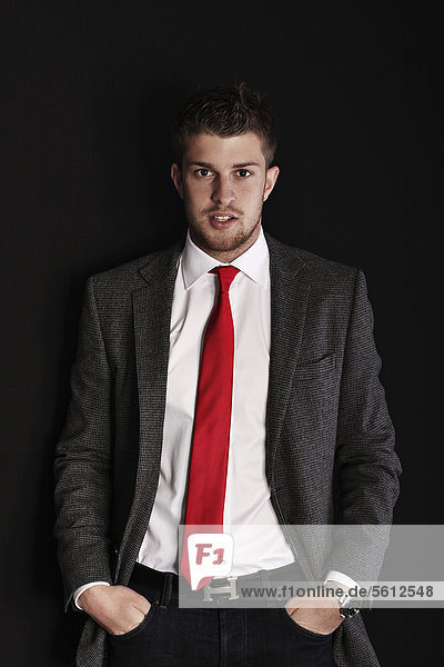 Young man wearing a suit  hands in pockets