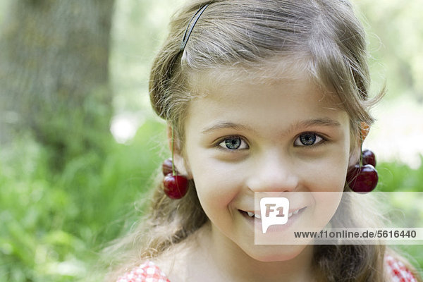 Girl with cherries dangling from her ears