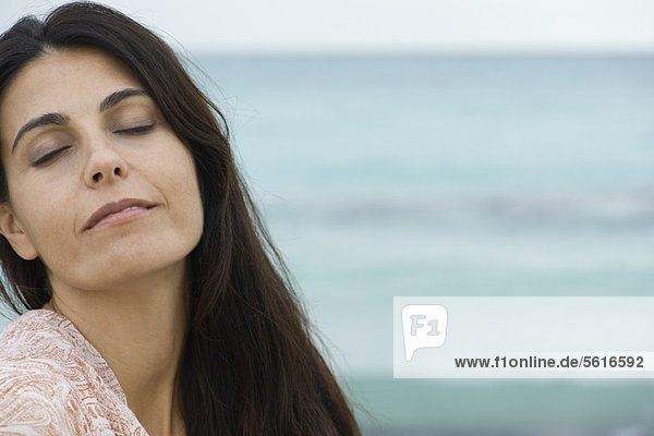 Woman at the beach  eyes closed  portrait