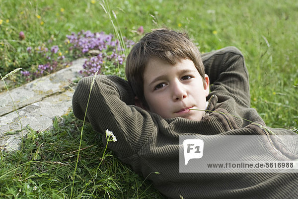 Junge entspannt auf Rasen  Portrait