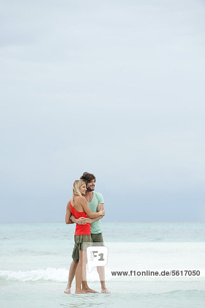 Couple embracing at the beach