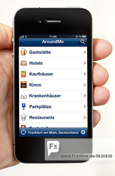 IPhone  smartphone  with the AroundMe app on the display  showing institutions  restaurants  banks  parking lots  etc. in the immediate vicinity