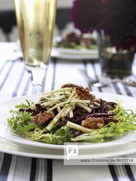 Frisee salad with walnuts  apple sticks and red beets