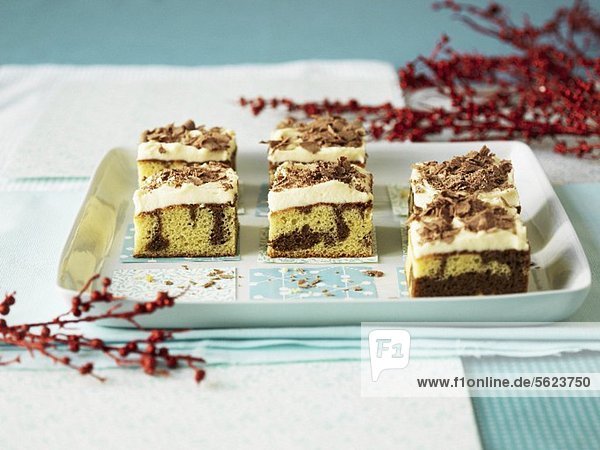Marble brownies with ricotta cream on a serving platter with winter theme