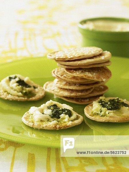 Sesame crackers with spread with soft cheese and pesto