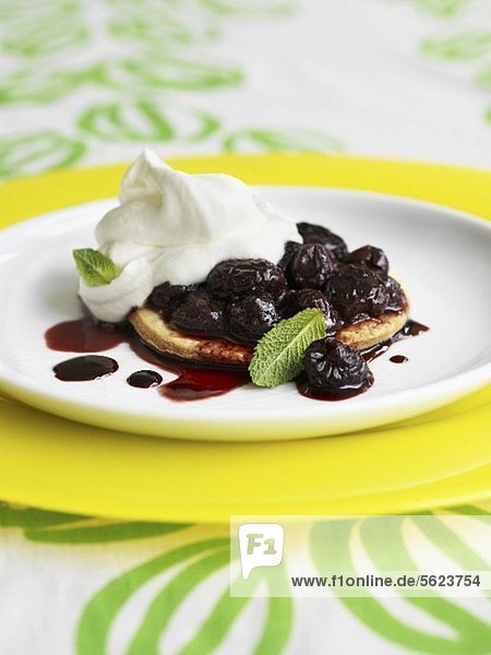 Mini cherry tart with whipped cream