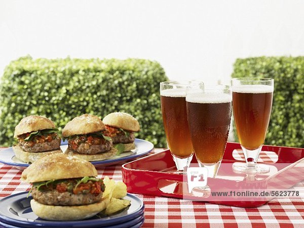 Hamburger and beer on a picnic table