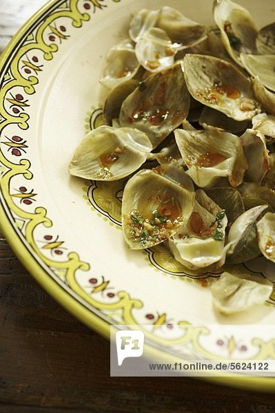 Steamed Artichoke Leaves With Harissa Dressing