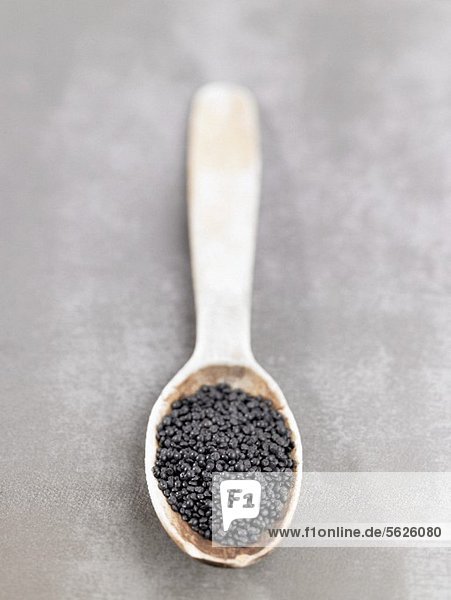 Beluga lentils on a wooden spoon