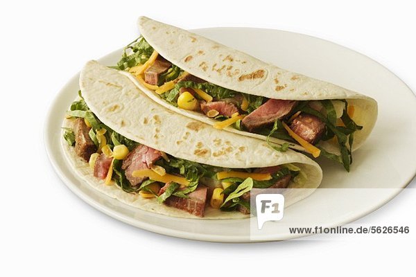 Two Beef Soft Tacos on a White Plate  White Background