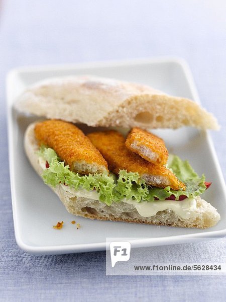 Sandwich mit Fischstäbchen  Salat und Mayonnaise
