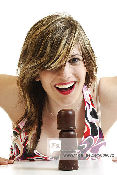 Smiling young woman with three stacked chocolate marshmallows