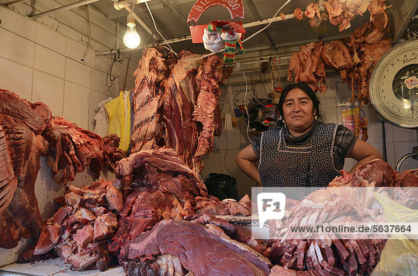 Saleswoman at a rustic meat counter  La Paz  Bolivia  South America