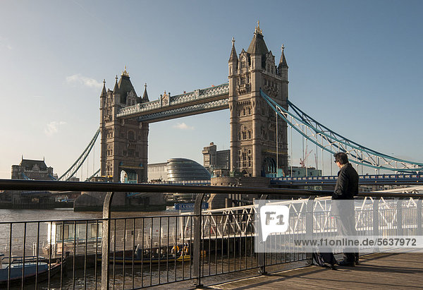 Man observes Tower Bridge over River Thames  London Borough of Tower Hamlets  England  United Kingdom  Europe