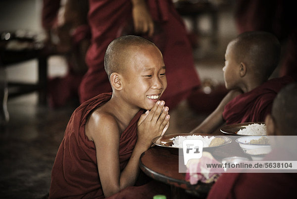 Buddhist novice praying  at table  Bagan  Burma  Myanmar  Southeast Asia  Asia