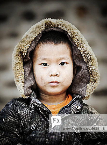 Boy wearing a hood  portrait  Yangon  also known as Rangoon  Myanmar  Burma  Myanmar  Southeast Asia  Asia