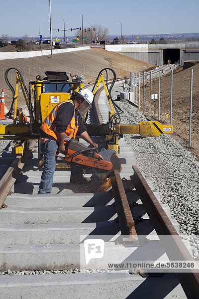 Worker building a light rail urban transit system linking Denver with its western suburbs  Lakewood  Colorado  USA