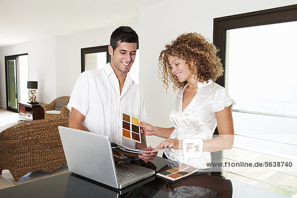 Couple examining swatches in home