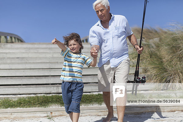 Man and grandson with fishing poles