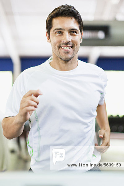 Mann mit Trainingsgerät im Fitnessstudio