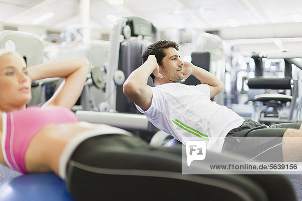 Couple working out together in gym
