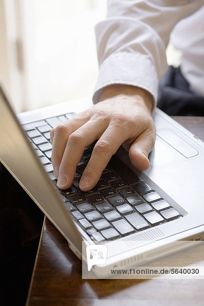 Close up of businessman using laptop