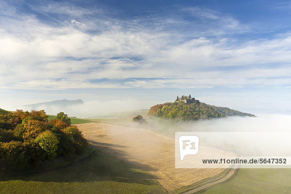 Maegdeberg mountain with the castle ruins above the autumn mist  Muehlhausen  district of Konstanz  Baden-Wuerttemberg  Germany  Europe