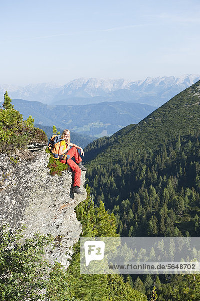 Austria  Salzburg  Hiker sitting on rock  portrait