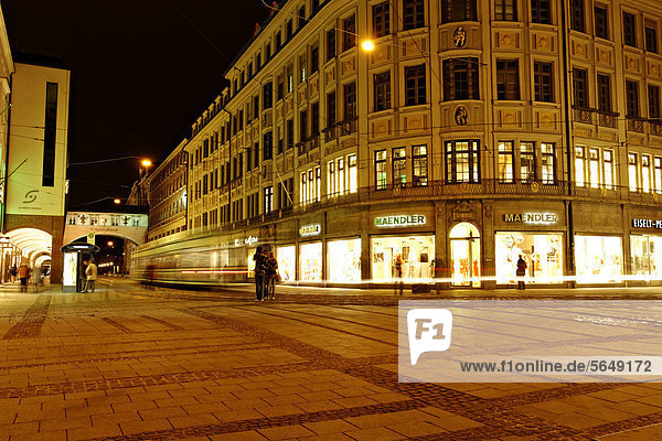 Maendler fashion shop boutique with passing tram at night in Maffeistrasse  Munich  Upper Bavaria  Germany  Europe