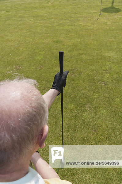 Germany  North Rhine Westphalia  Duesseldorf  Golfer playing golf