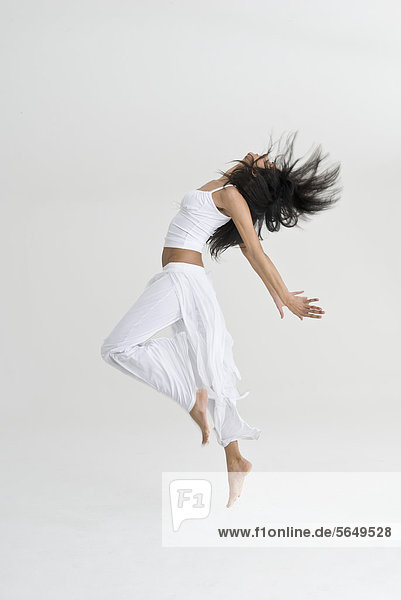 Young woman jumping and dancing
