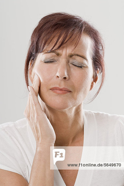Mature woman with toothache  close up