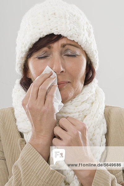 Mature woman using handkerchief  close up