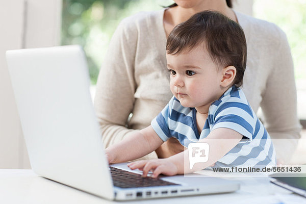 Baby boy using laptop