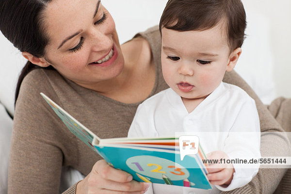Mother reading with baby son