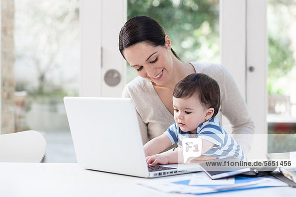Mother and baby boy using laptop