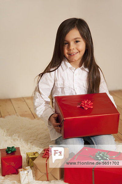 Girl with christmas present  smiling  portrait