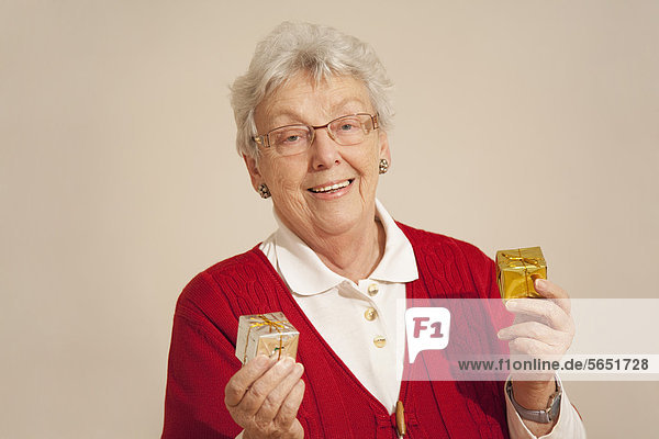 Senior woman with gift box during christmas  smiling  portrait