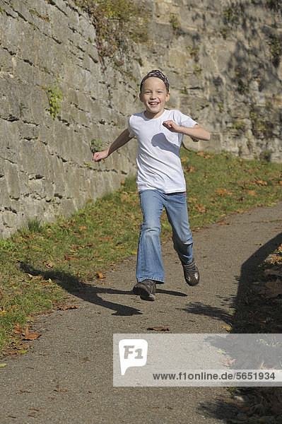 Girl running on footpath  portrait