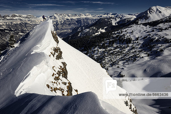 Climber on mountain top with mountain panorama  Firtzstock  Glarus  Eastern Switzerland  Switzerland  Europe
