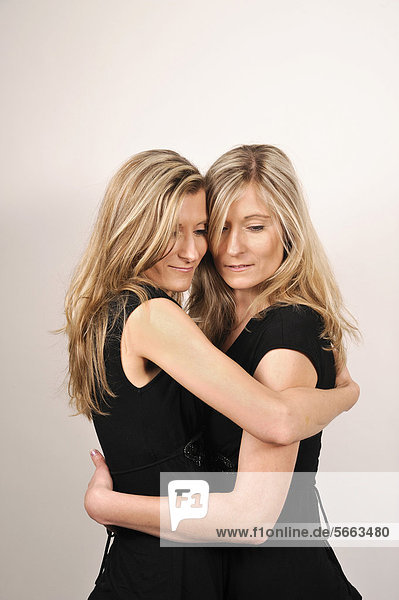 Twin sisters hugging