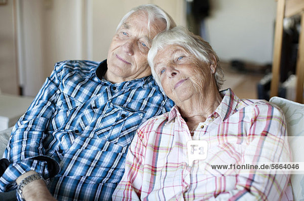 Senior couple relaxing together on sofa in living