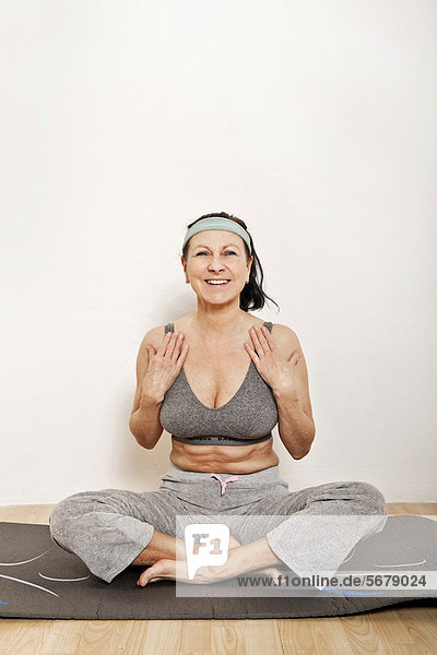 Woman on an exercise mat  doing yoga or gymnastics